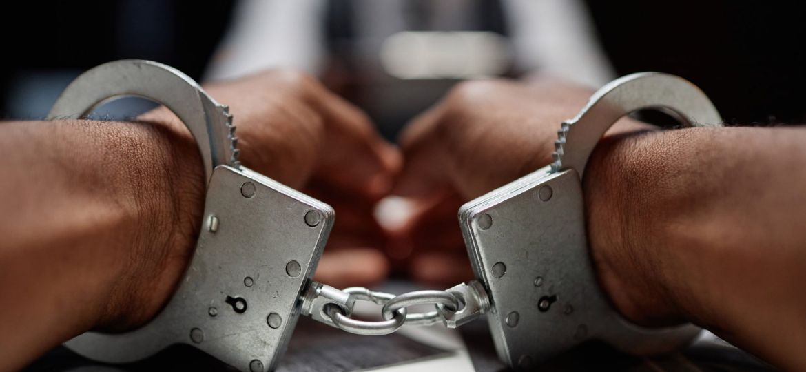 dramatic-close-up-of-black-man-wearing-handcuffs-o-2023-10-05-18-25-29-utc (Demo)